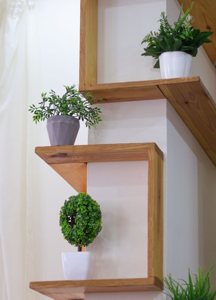 About Wooden shelves adorned with decorative potted plants adding freshness to indoor decor.
